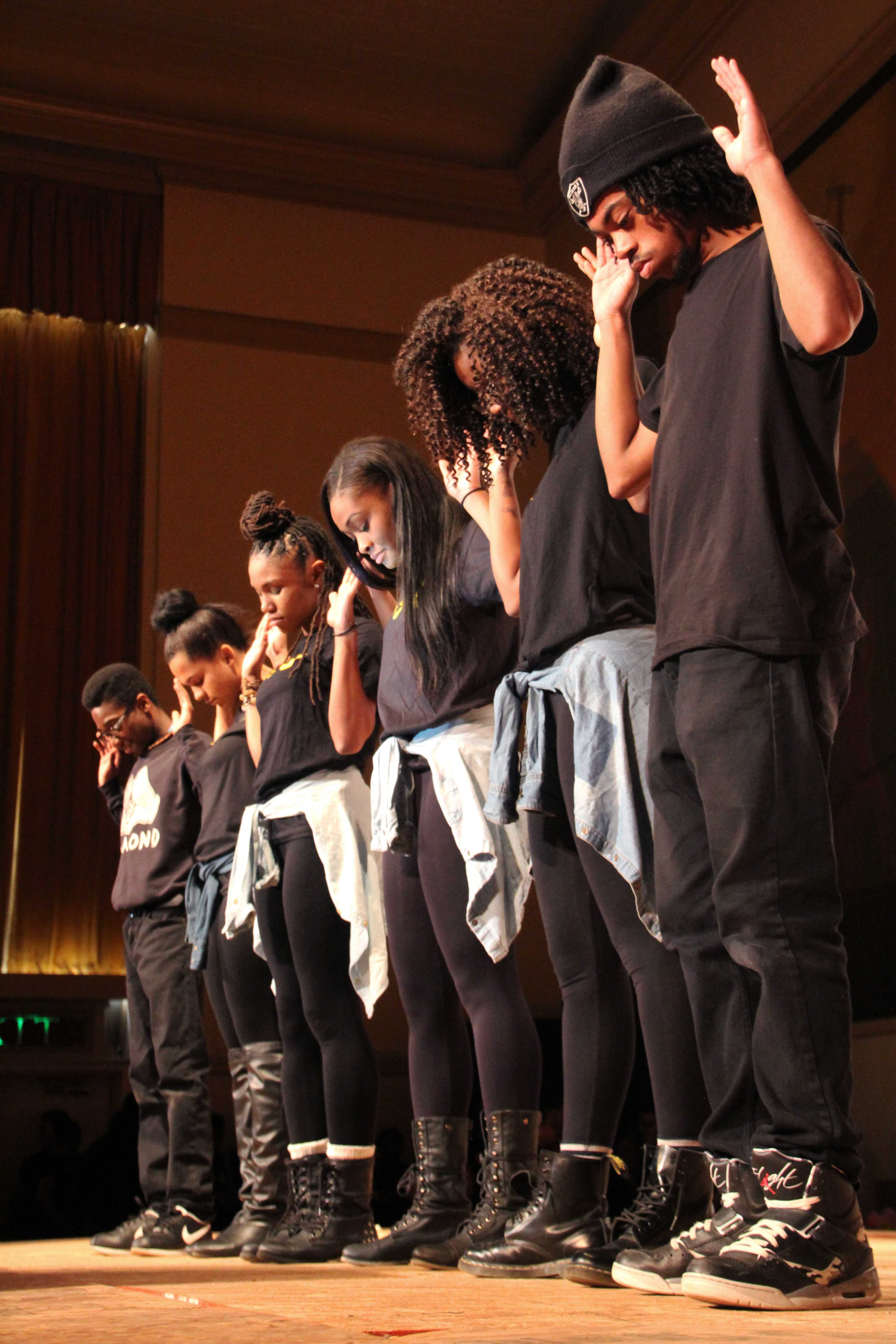 Members from Grant High's Black Student Union stand in solidarity with their arms raised, symbolizing the Civil Rights tag "Hands up, Don't Shoot" at the recent Black History Month assembly. This year, the BSU member chose to raise awareness to the current struggles of African Americans for the assembly.