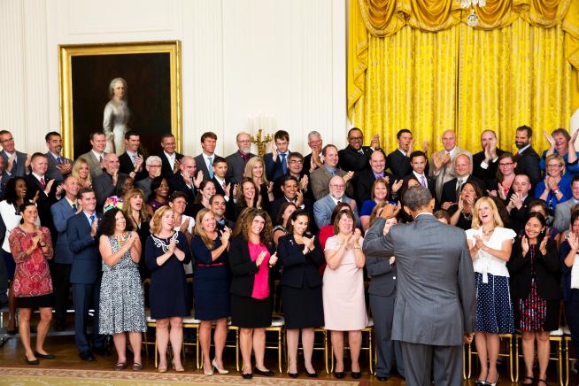 Schraer far left, applauding with 99 of the awardees from around the country when Obama walked into the room to greet them.