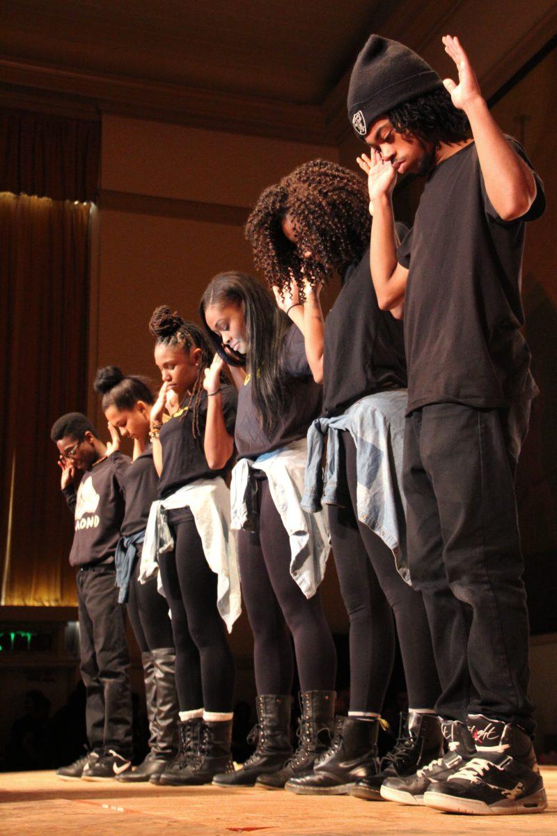 Members from Grant High's Black Student Union stand in solidarity with their arms raised, symbolizing the Civil Rights tag "Hands up, Don't Shoot" at the recent Black History Month assembly. This year, the BSU member chose to raise awareness to the current struggles of African Americans for the assembly.