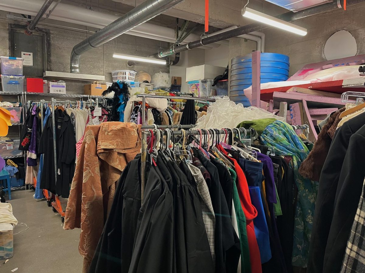 Cluttered props and costumes in basement storage room 032.