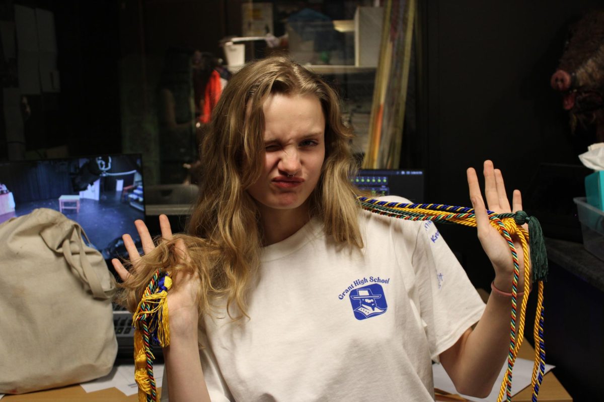Celia Ketchum wearing her PSU, PCC, NHS and CTE cords. Before the new policy she would have also earned a cord for Thespians and eight credits of math and science.
