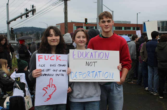 Students holding anti-U.S. Immigration and Customs Enforcement signs.
