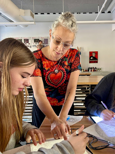 Melody Rockwell guides students through a mandala project in her Grant High School art classroom, offering feedback while encouraging creativity and personal expression.
